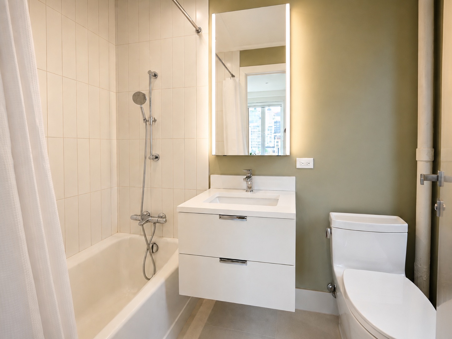 Second bathroom with soaking tub and city view