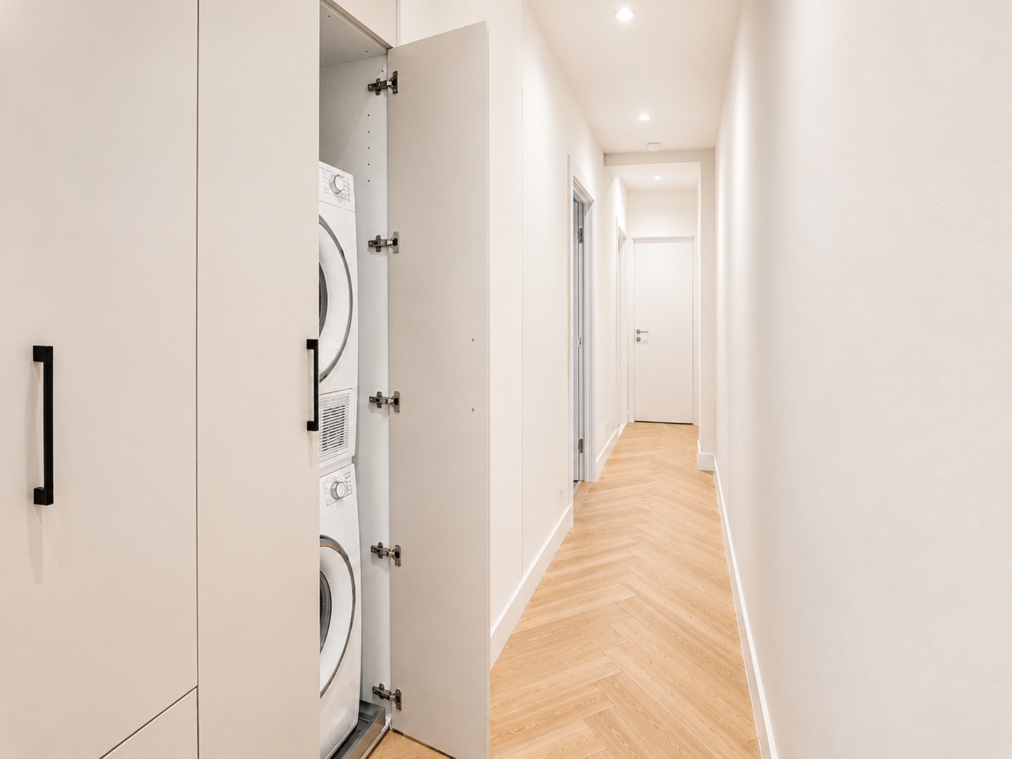 Hallway with concealed in-unit washer and dryer